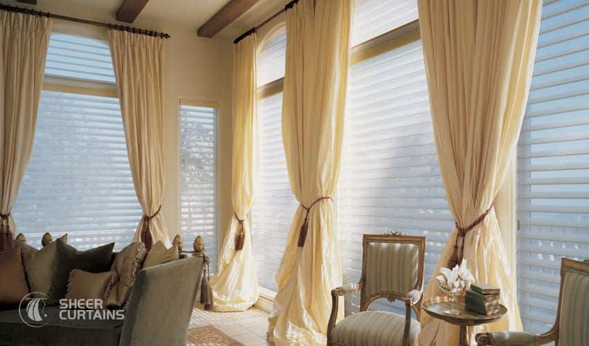 Buy Extra Long Curtains & hang them over the Existing curtain rod